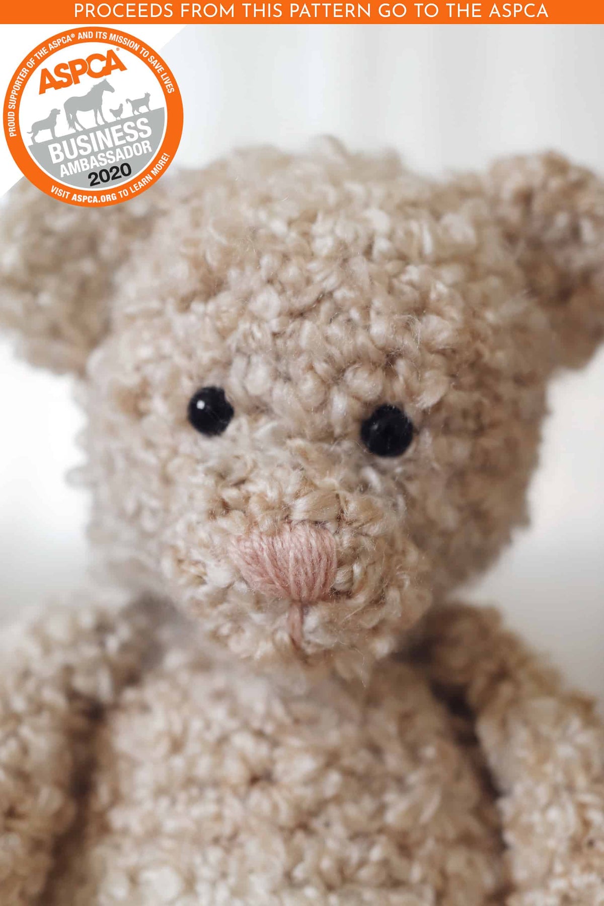 Crocheted teddy bear amigurumi in cream yarn with black safety eyes and embroidered nose by Darling Jadore