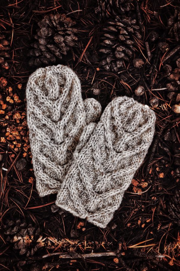 Hand-knit cable mittens in natural light displaying cozy texture