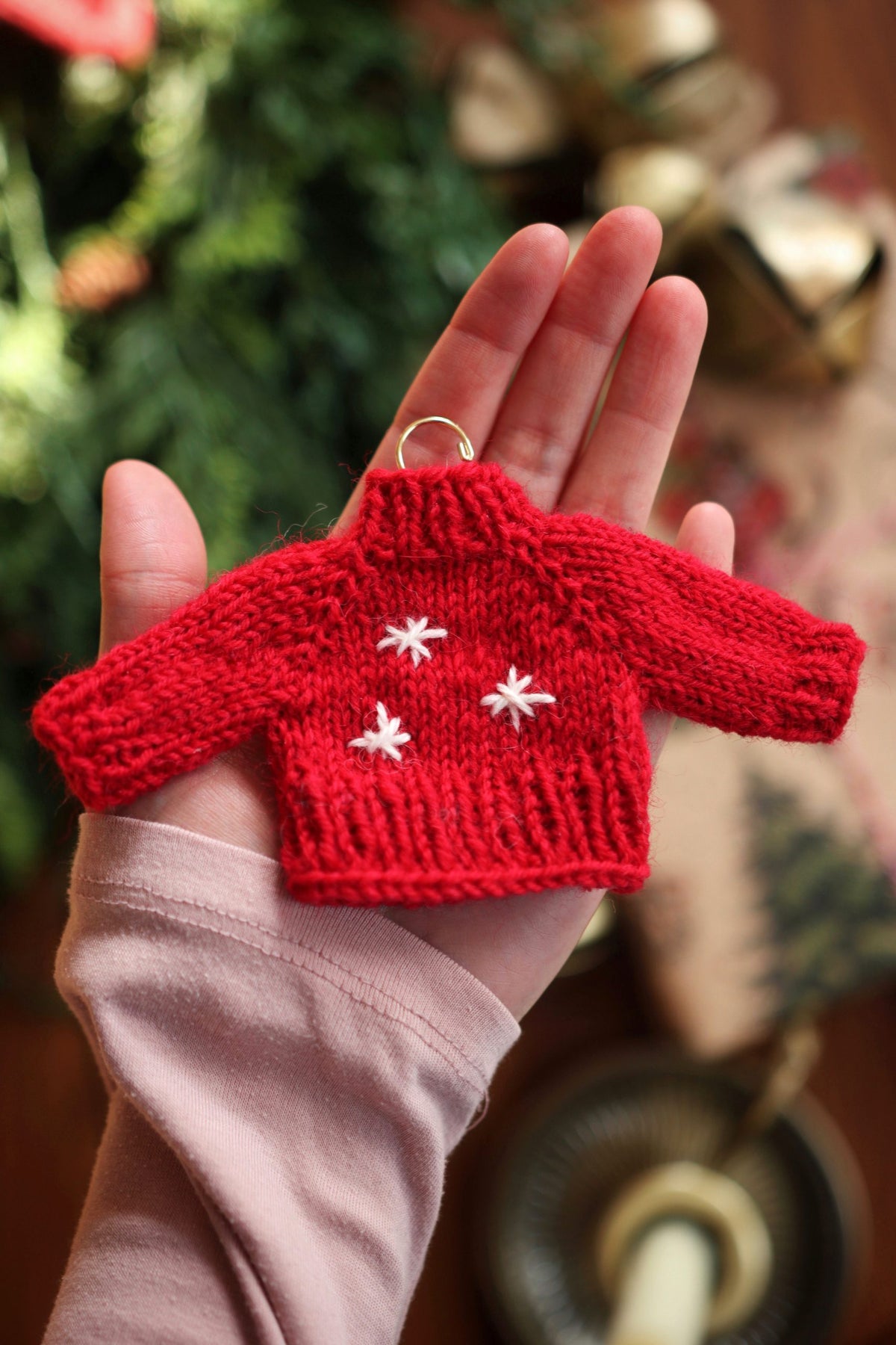 Miniature knitted sweater ornament in cream yarn hanging on Christmas tree - holiday knitting pattern by Darling Jadore