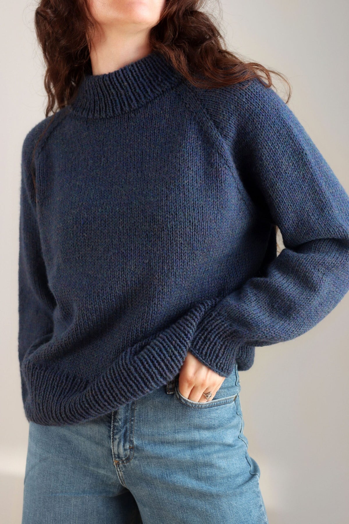 Person wearing a cozy blue sweater