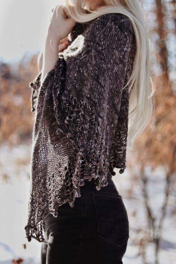 Triangular lace shawl in soft yarn draped over shoulders - Moonlit Shawl knitting pattern by Darling Jadore