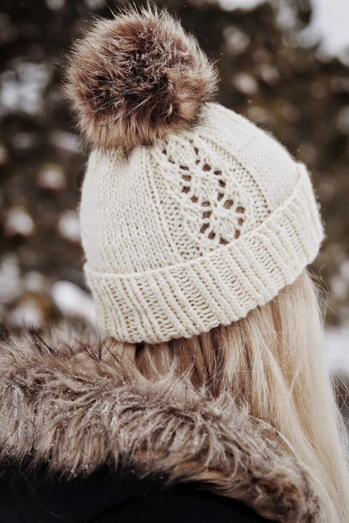 Cream ribbed knit beanie with folded brim shown on wooden surface - Phlox Beanie knitting pattern by Darling Jadore