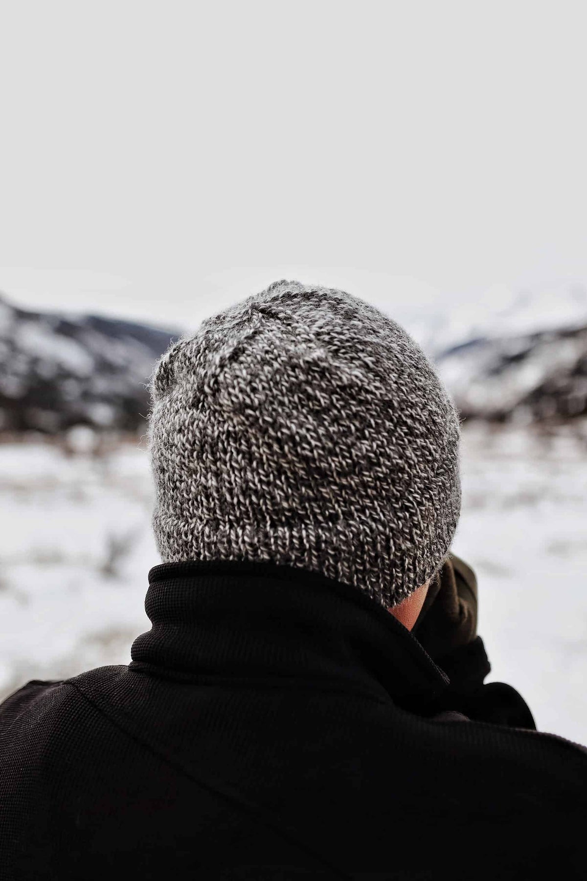 Man wearing cream ribbed knit beanie outdoors - Cabin Beanie knitting pattern by Darling Jadore