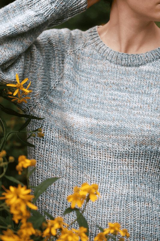 Close up of ribbed cuffs and hem detail on River Sweater knitting pattern