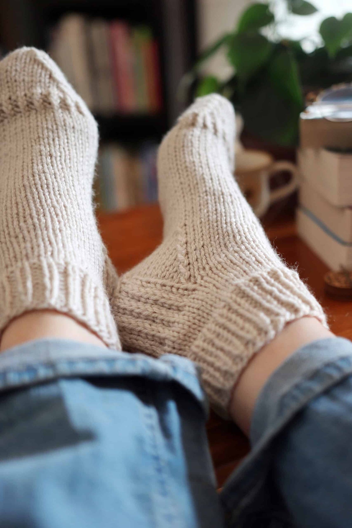 Woman wearing cream worsted weight ankle socks beginner knitting pattern