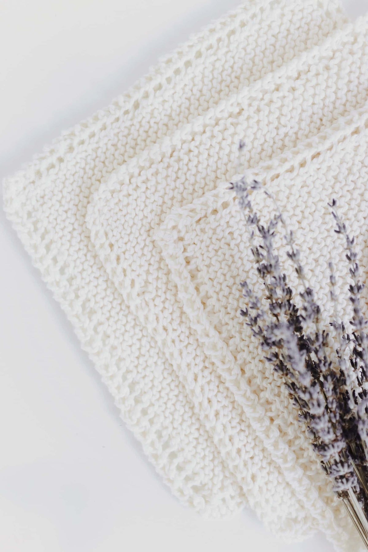 Beginner-friendly bias knit washcloth pattern in natural cotton - easy garter stitch knitting project