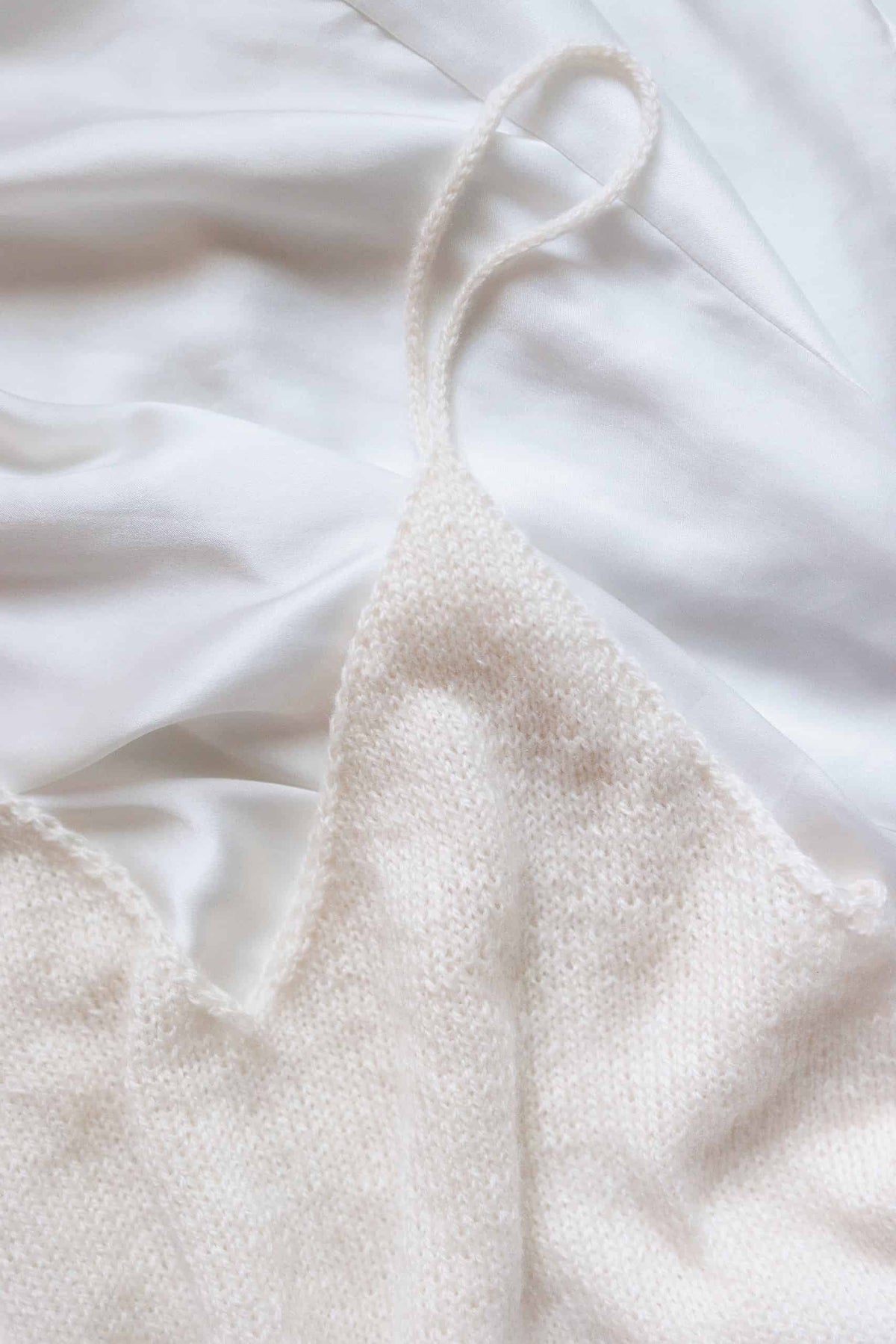 Close-up of elegant knitted tank top camisole pattern showing lightweight texture and feminine design