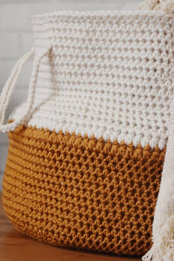 Crochet belly basket storage solution with handles in modern home interior
