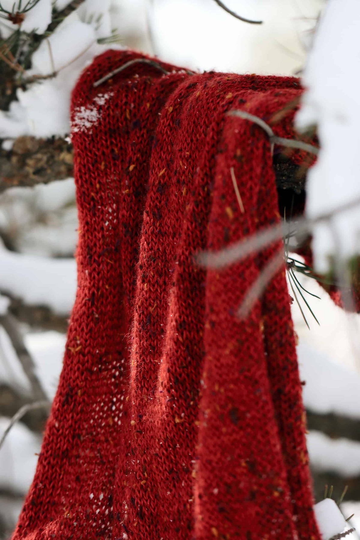 Woman styling red hand knit scarf outdoors - The Favorite Scarf pattern by Darling Jadore