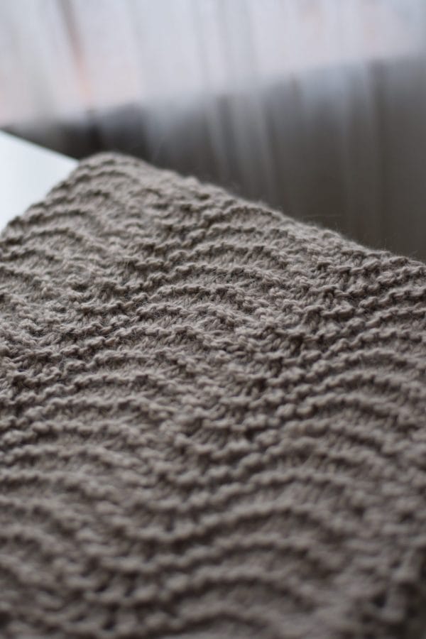 Fauna cowl knitting pattern styled with neutral tones showing timeless lace design
