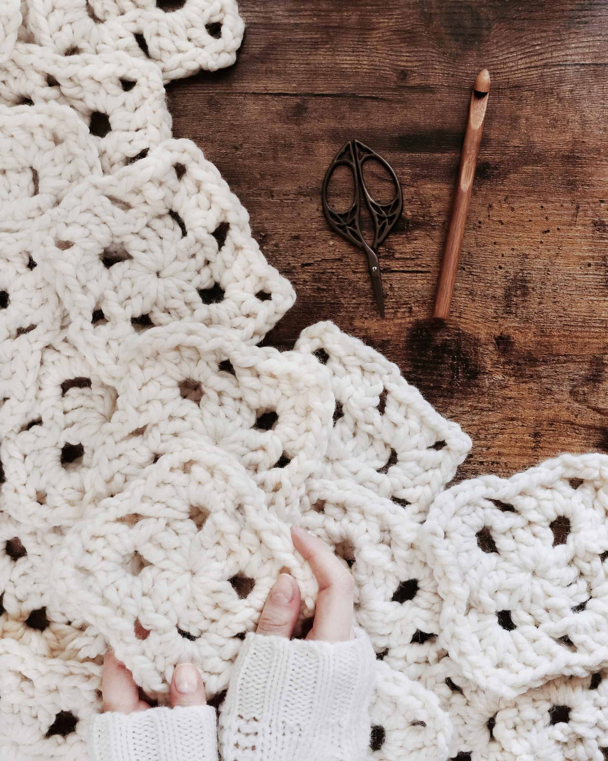 Magnolia Throw crochet pattern lifestyle shot - cozy blanket in modern farmhouse living room setting