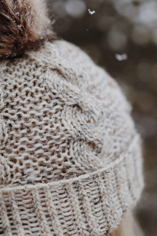 Cable knit hat pattern detail showing seamless construction and classic beanie silhouette