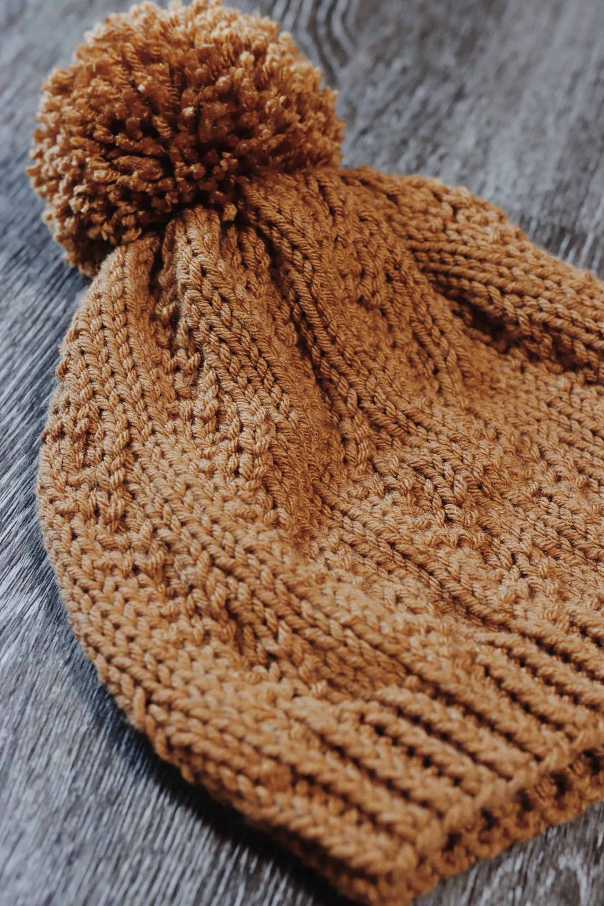 Side view of Prairie Beanie showing textured faux cable pattern and ribbed brim