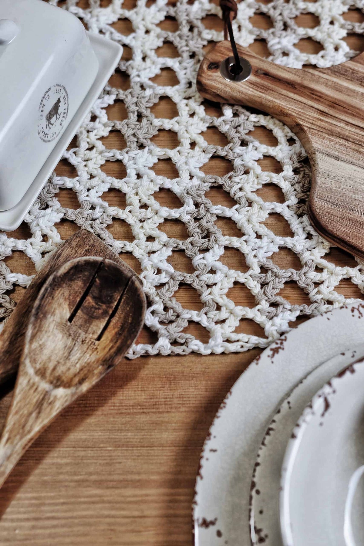 Close up of lace crochet table runner pattern showing delicate stitch detail and color transitions