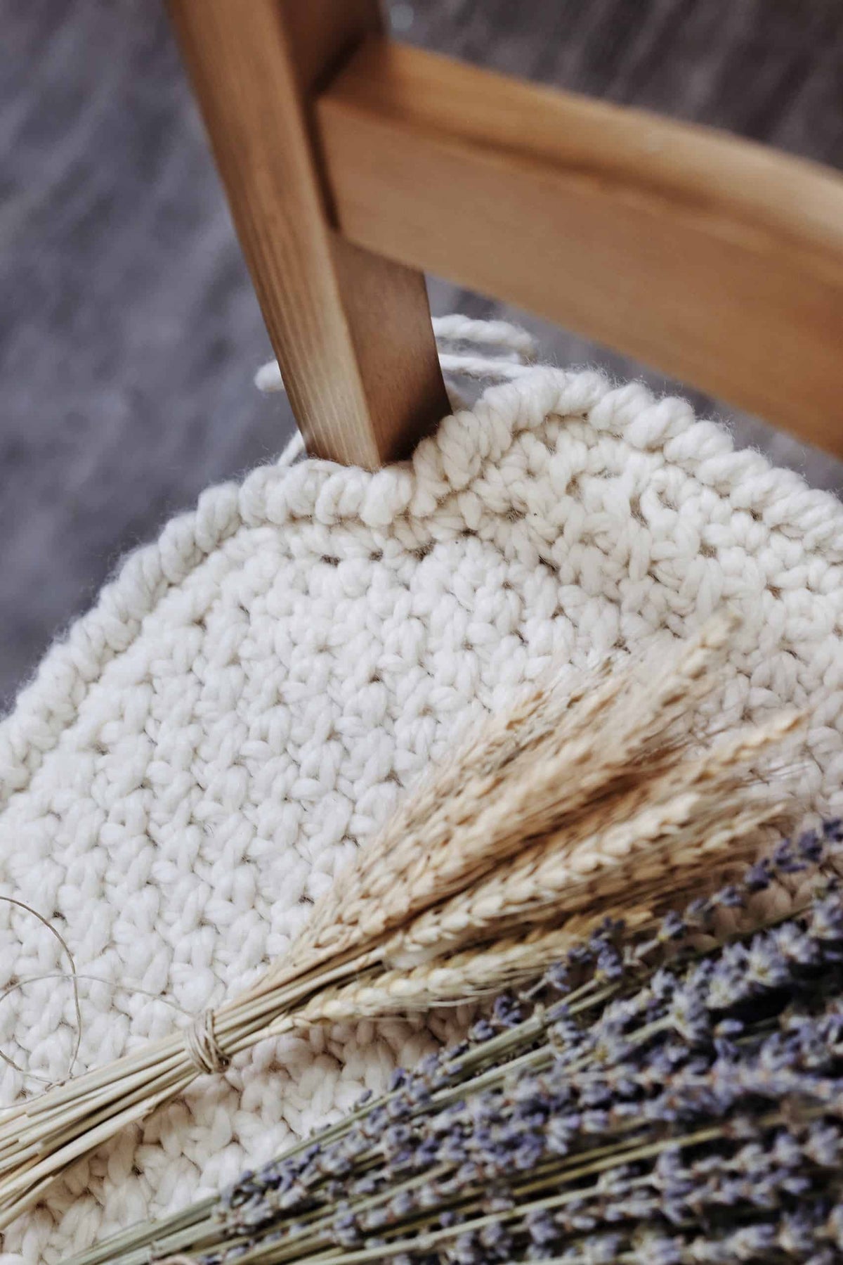 Classic chair cushion crochet pattern with woven texture on wooden dining chair in farmhouse style kitchen