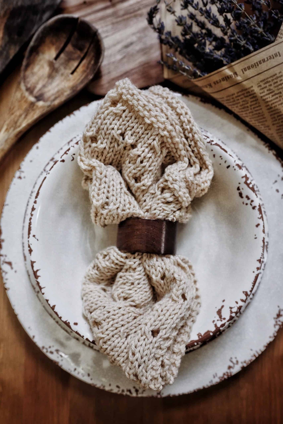 Eco-friendly knit napkin with farmhouse style lace border displayed on rustic wooden surface