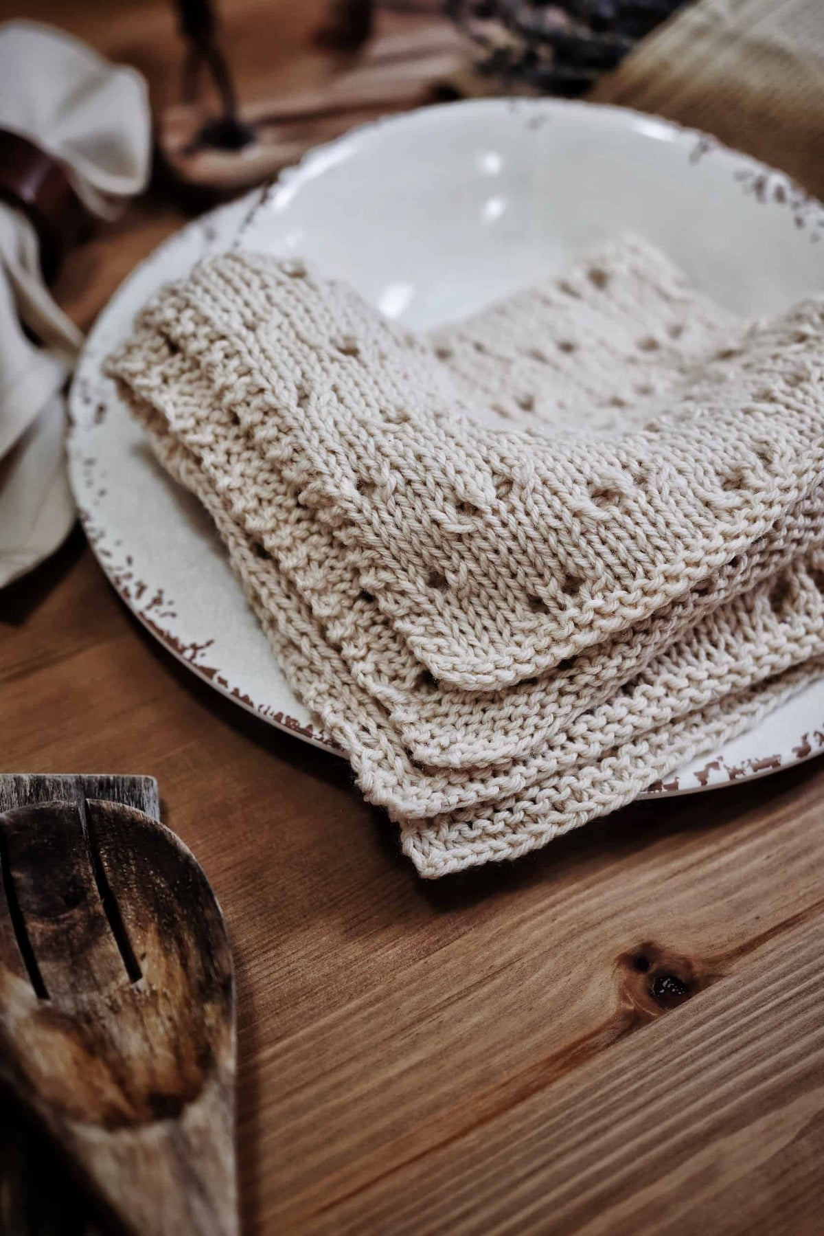 Close-up of lace detail on knitted napkin showing eyelet pattern and stockinette stitch background