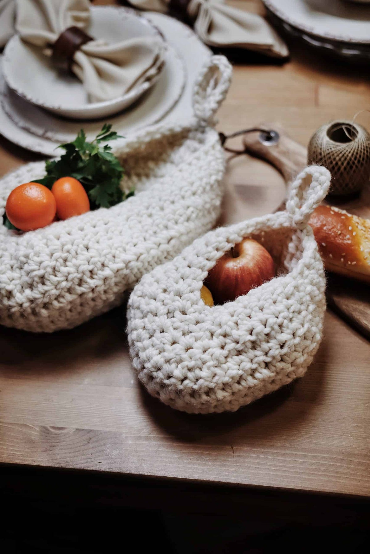Kitchen storage pouch crochet pattern hanging with vegetables in minimalist home