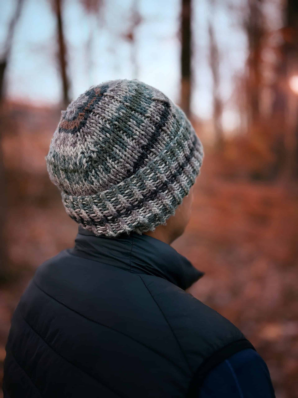 Man modeling ribbed camo beanie knitting pattern outdoors