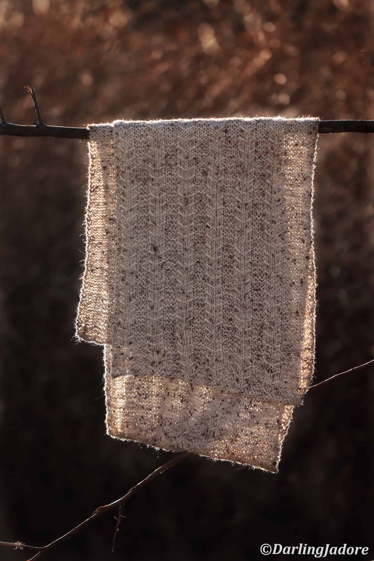Woman wearing elegant textured wrap scarf in neutral tones styled for fall