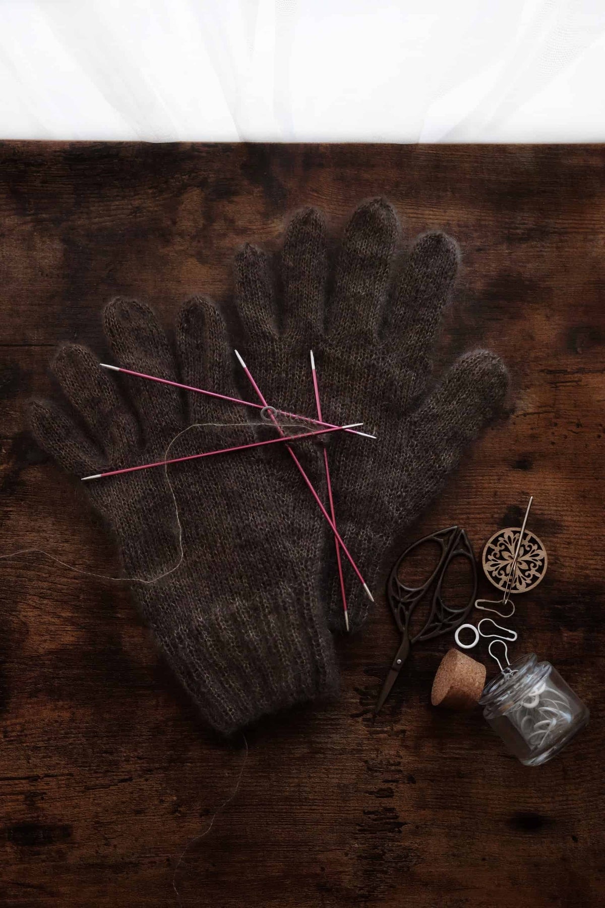 Pair of finished Cloud Gloves from intermediate knitting pattern in soft cream mohair yarn