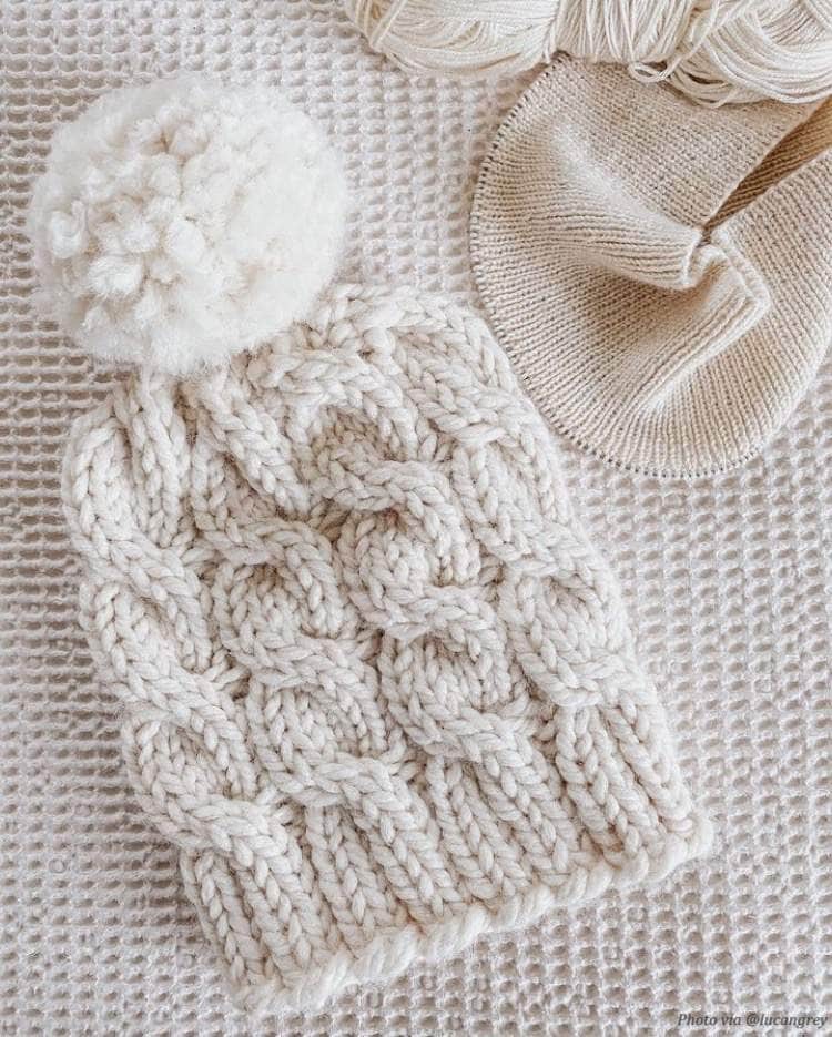 Close up of cable knit beanie pattern detail showing ribbed brim and textured stitches