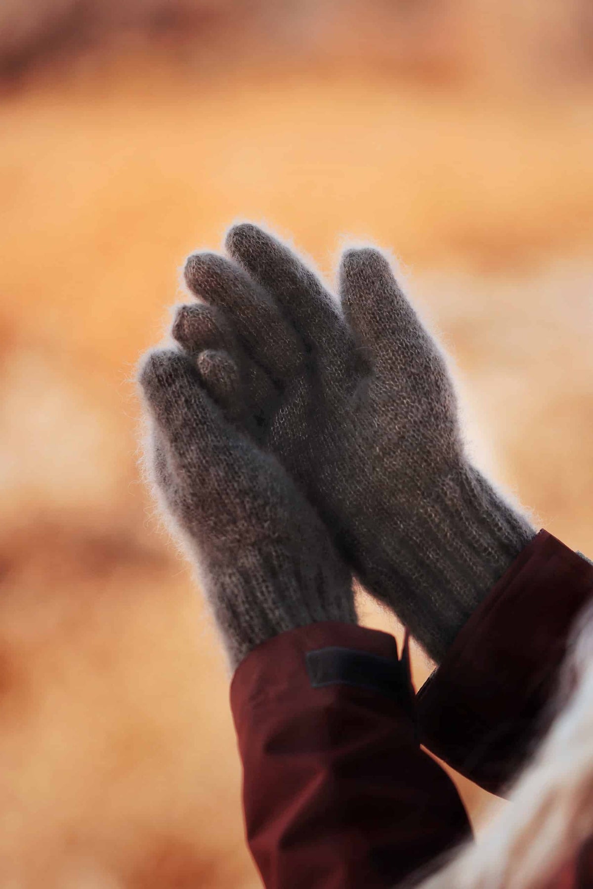Woman wearing cream mohair Cloud Gloves knitting pattern outdoors in autumn setting