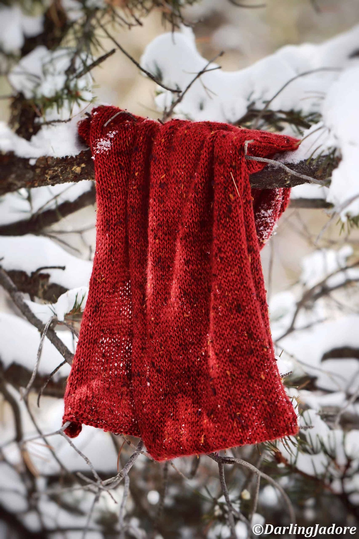 Woman wearing red hand knit scarf - The Favorite Scarf beginner knitting pattern by Darling Jadore