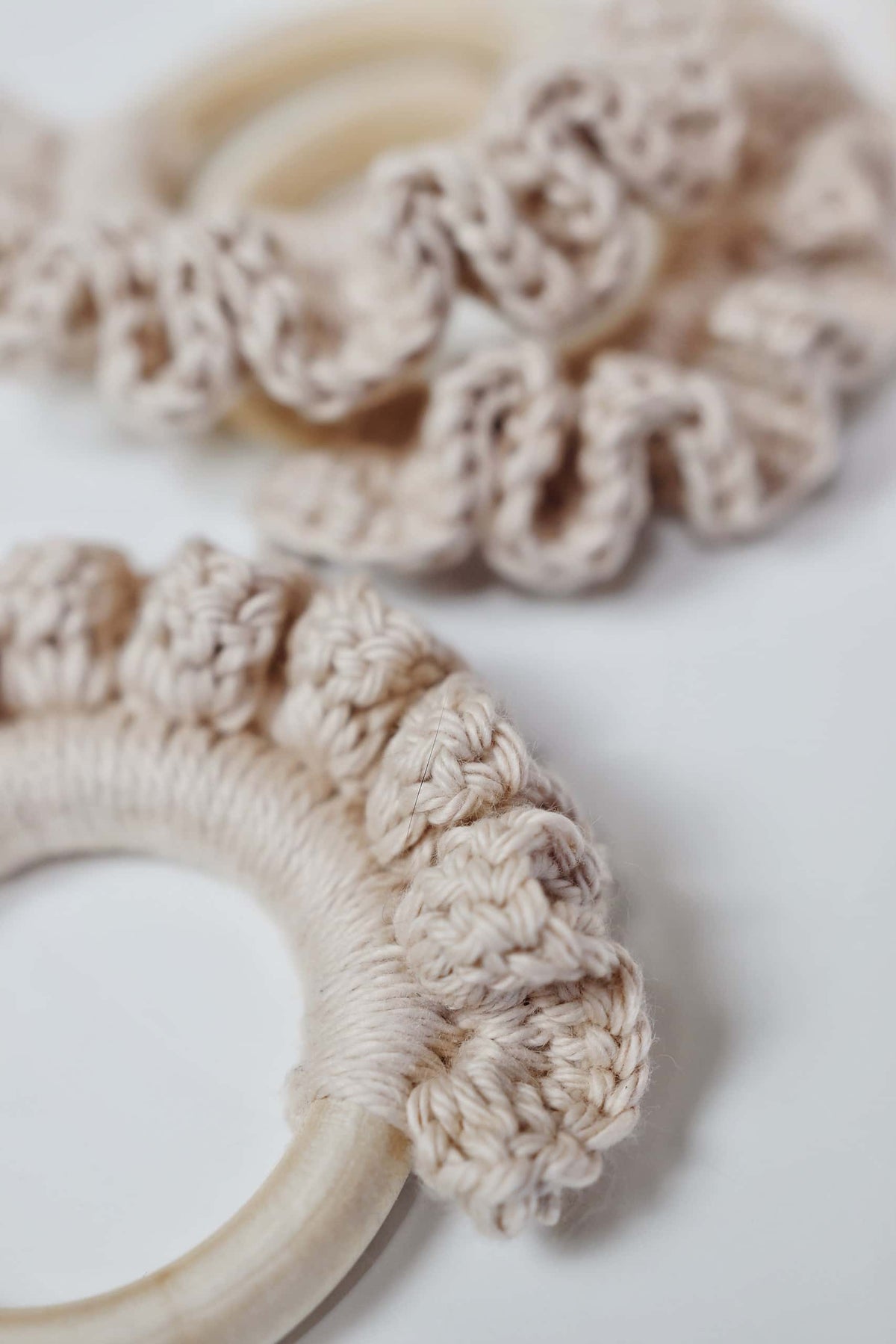 Beginner friendly crochet teether pattern with ripple design around natural wood ring