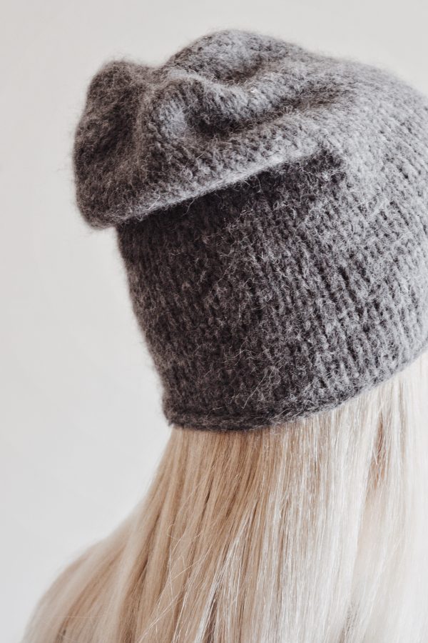 Side view of cream slouchy hat knitting pattern with effortless drape and timeless style