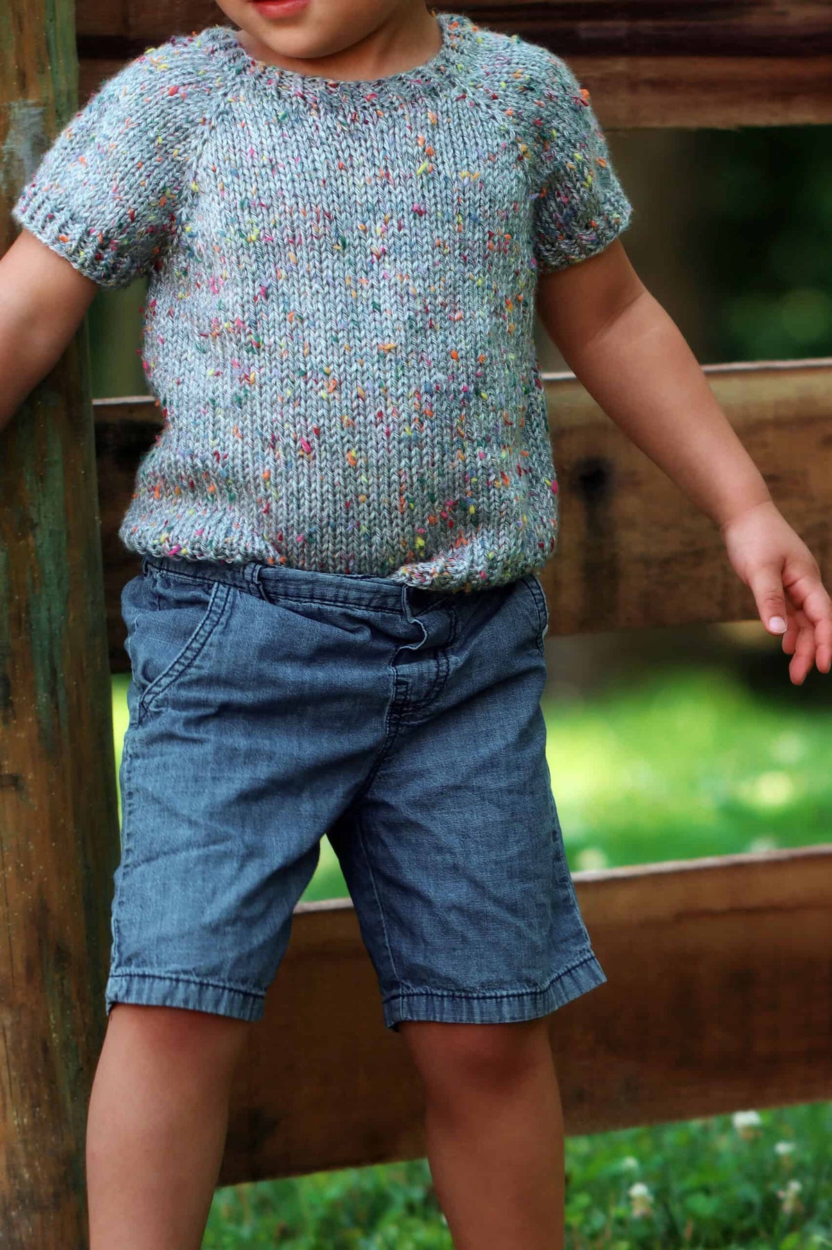 Back view of handknit baby tee showing smooth stockinette stitch finish