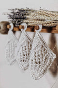 Handknit lace coaster with wheat-inspired detail on wooden table - farmhouse home decor knitting pattern