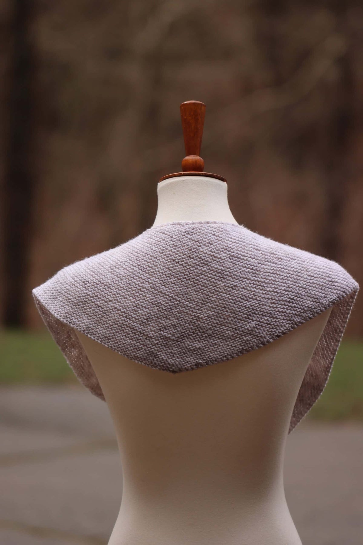 Woman wearing Sunday scarf knitting pattern showing elegant asymmetrical drape