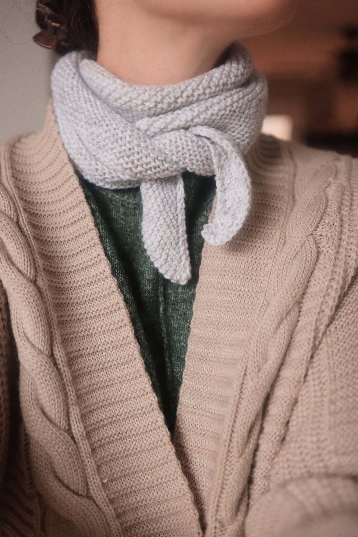 Small knit scarf in cream yarn worn as neckerchief - Sunday Scarf knitting pattern by Darling Jadore