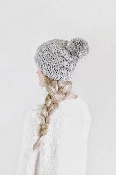 Side view of chunky cream beanie with textured ribbing and pom pom - beginner beanie knitting pattern