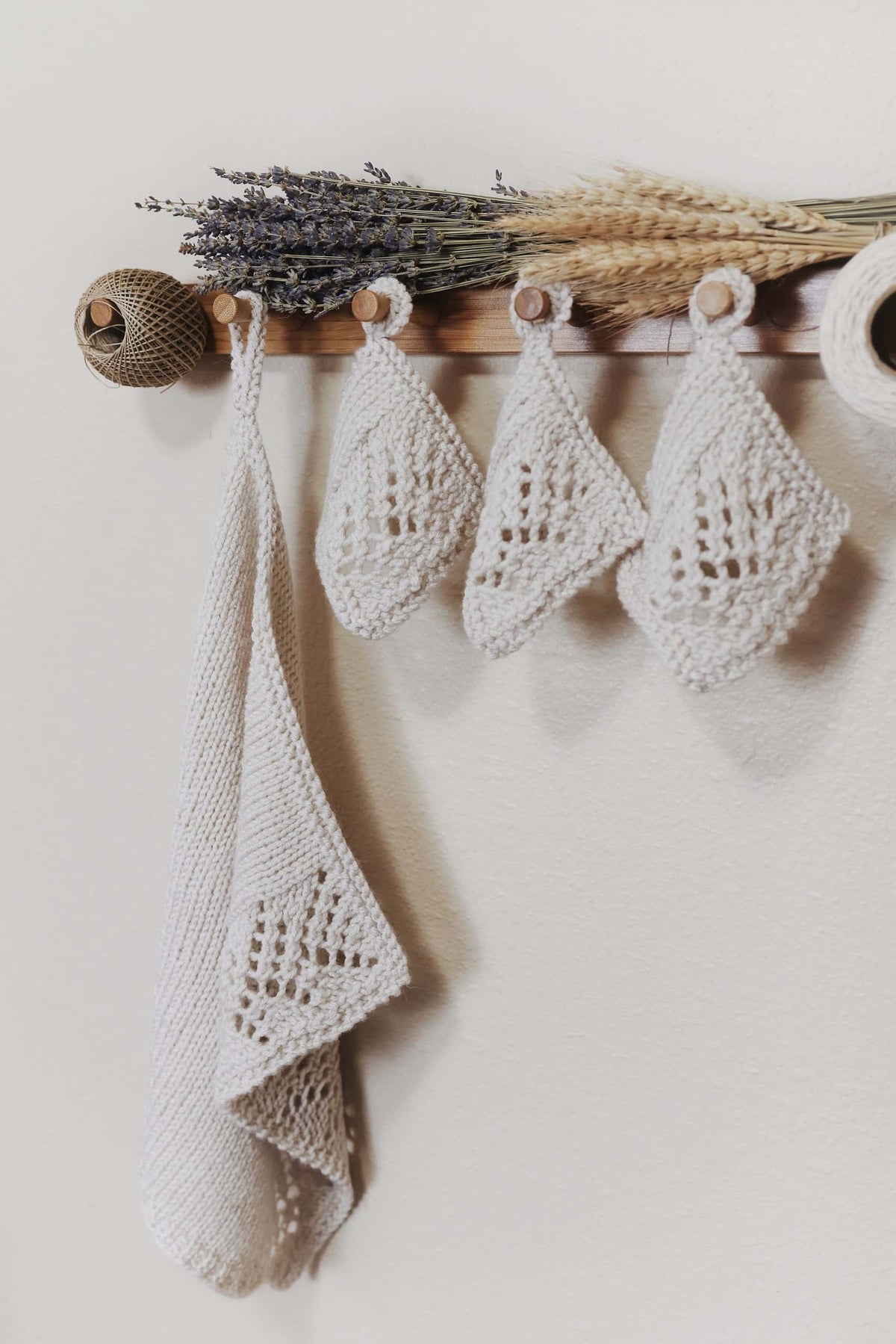 Knitted kitchen towel with wheat-inspired lace pattern draped elegantly