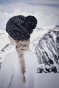 Woman wearing cream chunky knit beanie with pom - easy winter hat knitting pattern by Darling Jadore