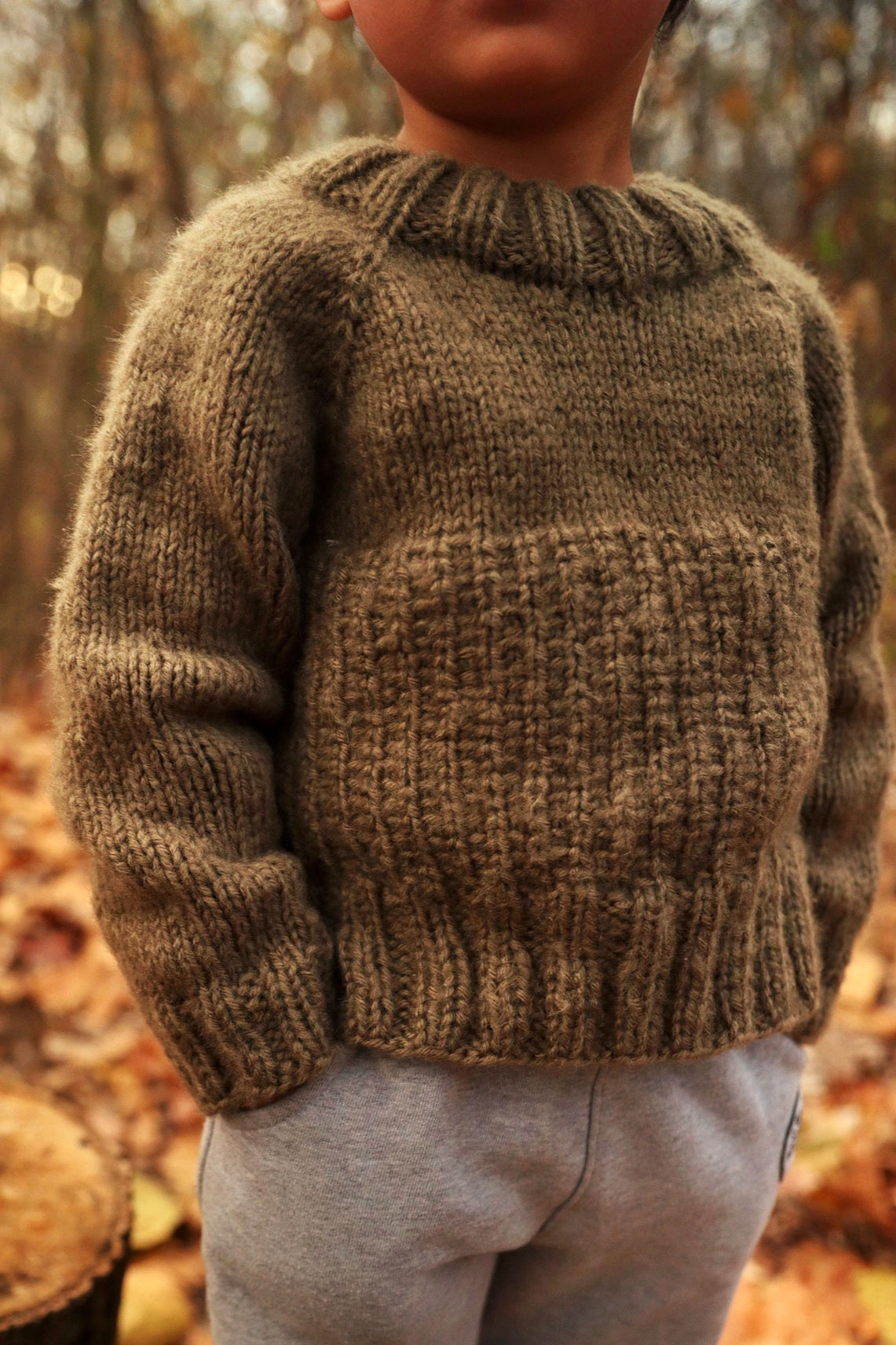 Child wearing cream raglan sweater with ribbed neckline - Sapling Sweater knitting pattern by Darling Jadore