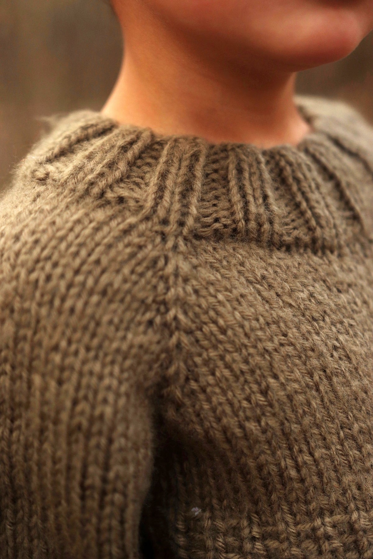 Child wearing cream raglan sweater with ribbed collar and cuffs - Sapling Sweater knitting pattern by Darling Jadore