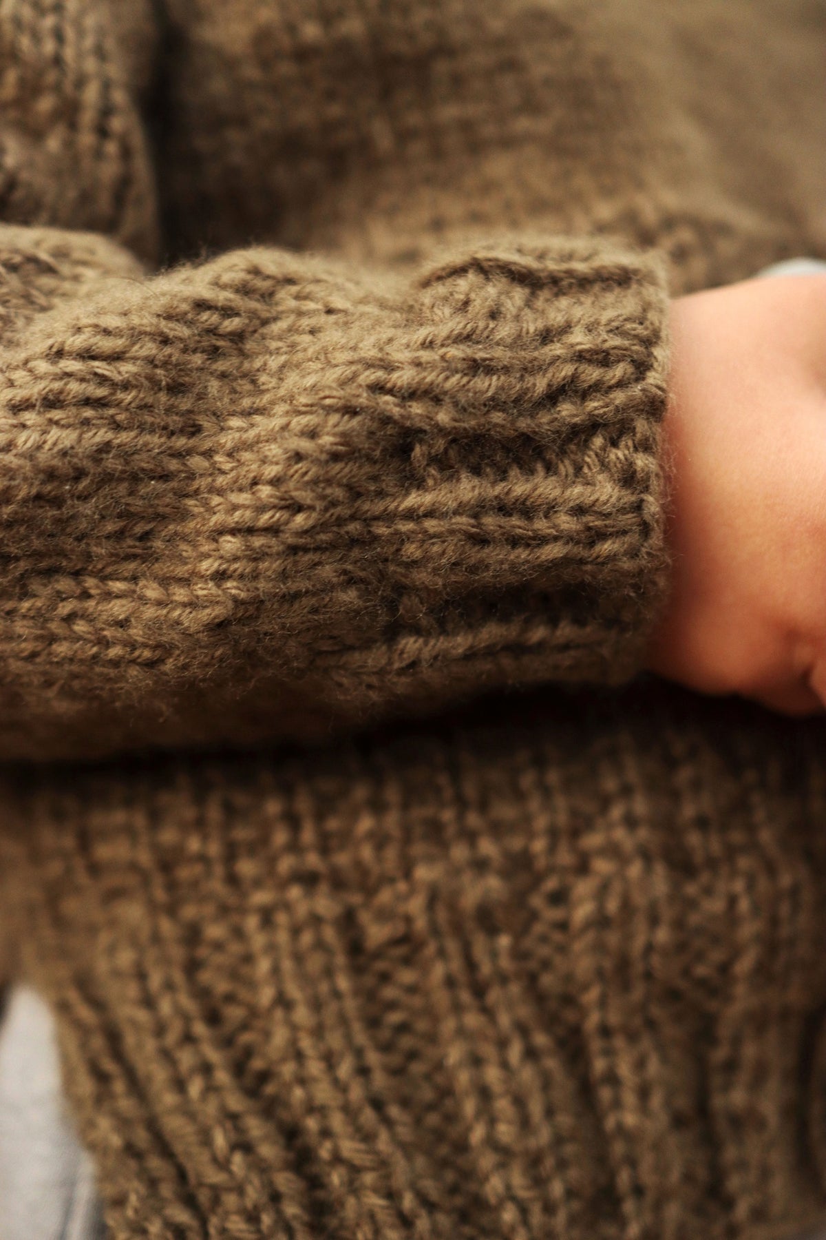 Child wearing cream raglan sweater with ribbed collar and cuffs - Sapling Sweater knitting pattern by Darling Jadore