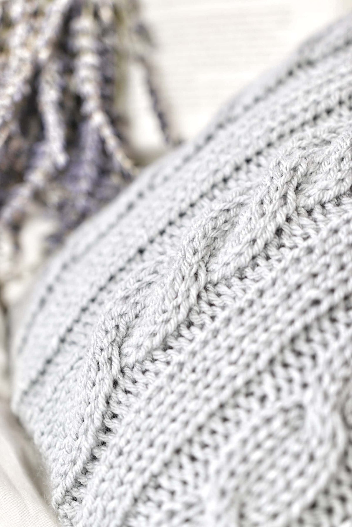 Side view of cable knit water bottle cozy showing dimensional texture and vintage charm