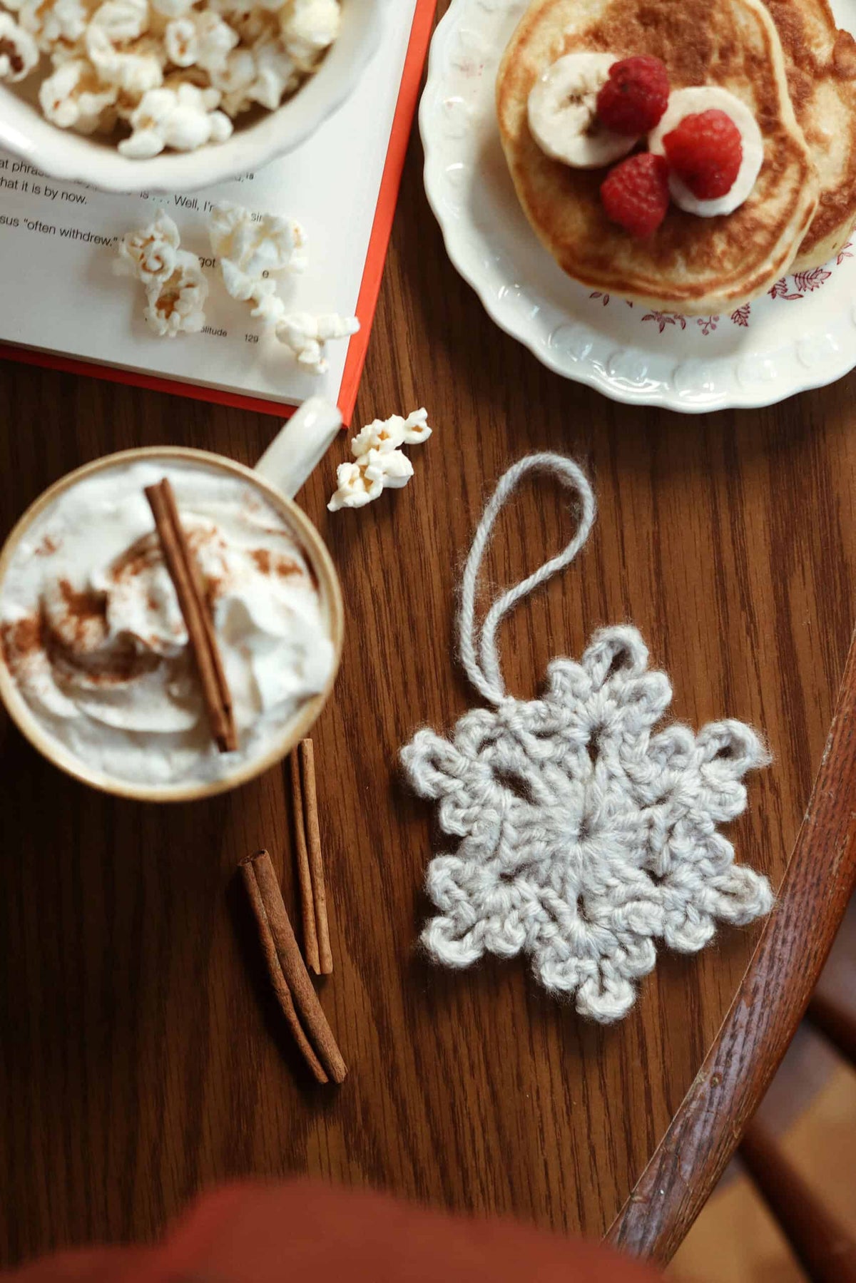 Beginner-friendly crochet snowflake pattern ornament on festive Christmas tree branch
