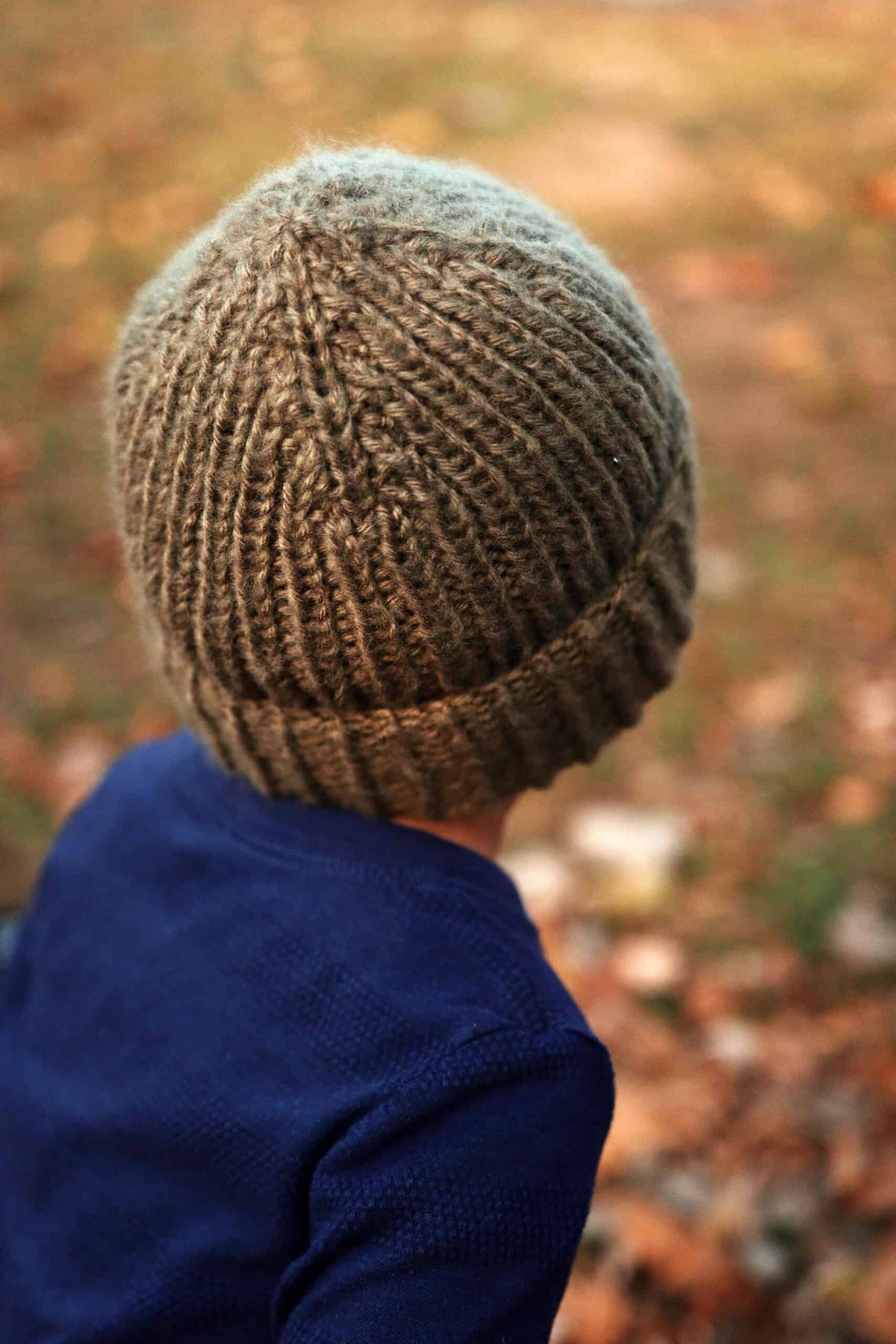 Side view of The Sprout Beanie knitting pattern showing seamless ribbed texture
