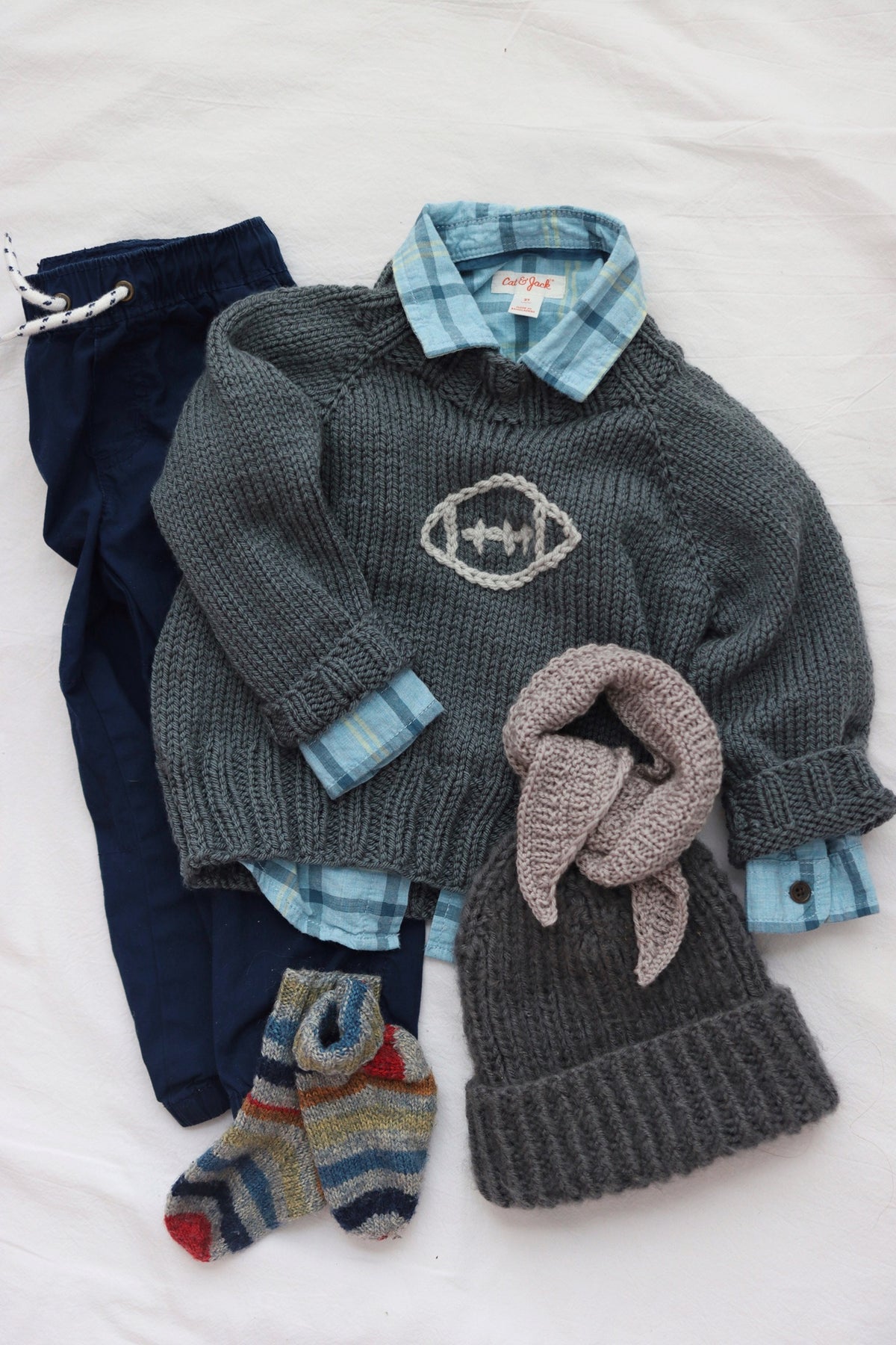 Close-up of toddler sweater knitting pattern showing seamless raglan construction and double-knit neckline detail