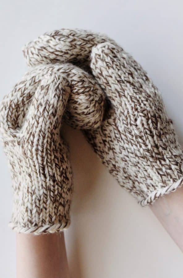 Close up of classic cream stockinette mittens with ribbed wrist - easy mittens knitting pattern