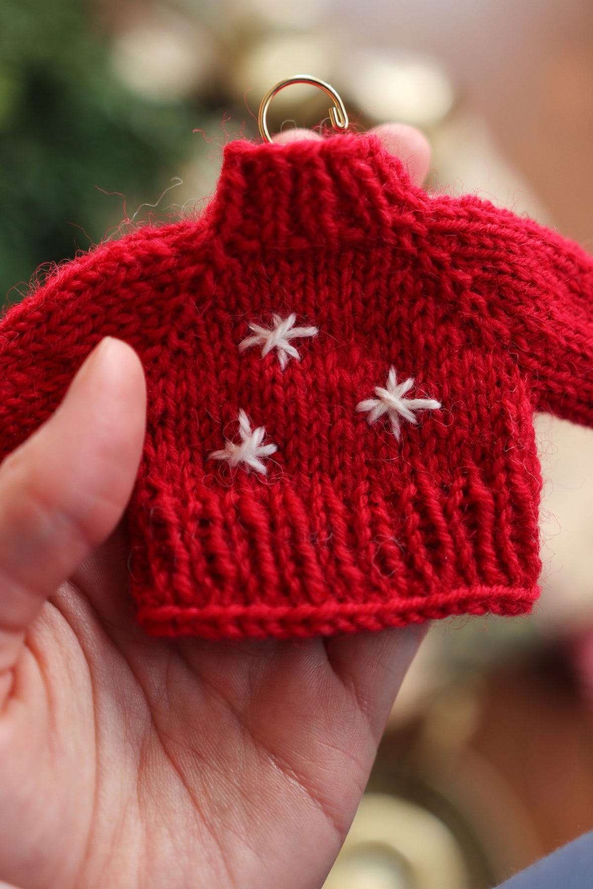 Handmade mini sweater ornament knitting pattern result in neutral tones for Christmas gifting