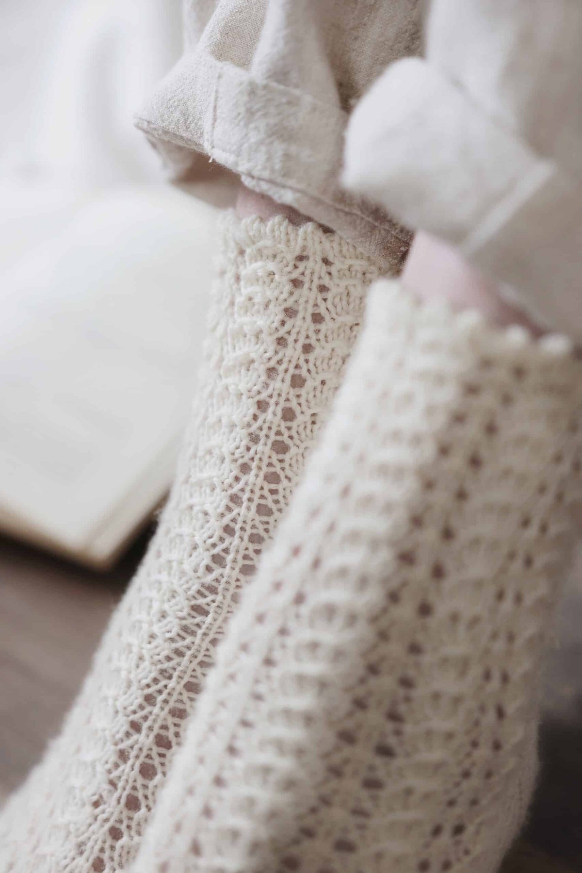 Side view of elegant lace socks showing intricate rosehip stitch pattern