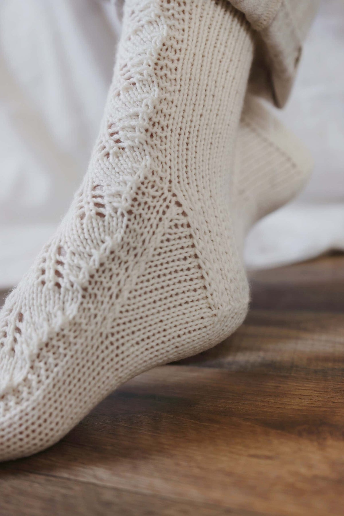 Lace knit socks in cream yarn with delicate eyelet pattern - Juniper Socks knitting pattern by Darling Jadore