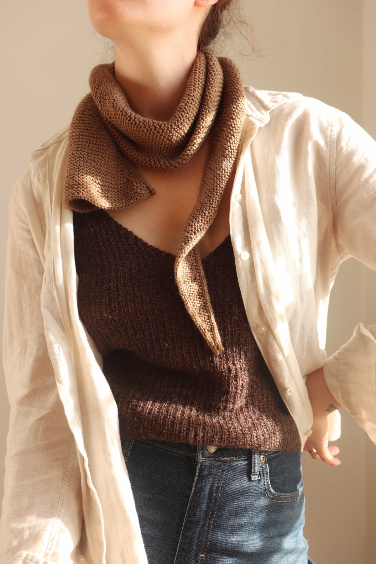 Brown knit scarf worn with a cream linen shirt - The Skysong Scarf Knitting Pattern by Darling Jadore