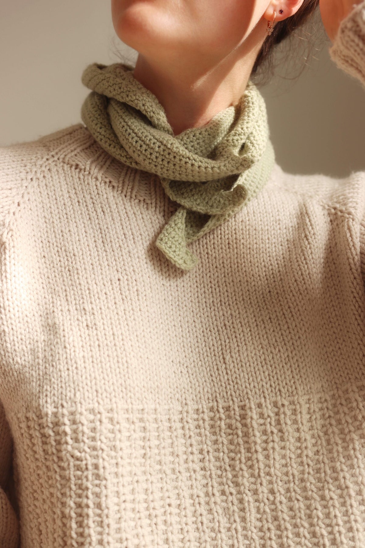 Sage green crochet scarf tied at the neck - The Saturday Scarf Crochet Pattern by Darling Jadore